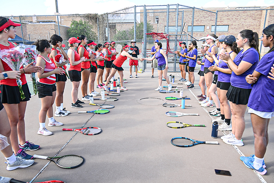 The Badgers and Rangers teams stand in rows with their racquets on the ground