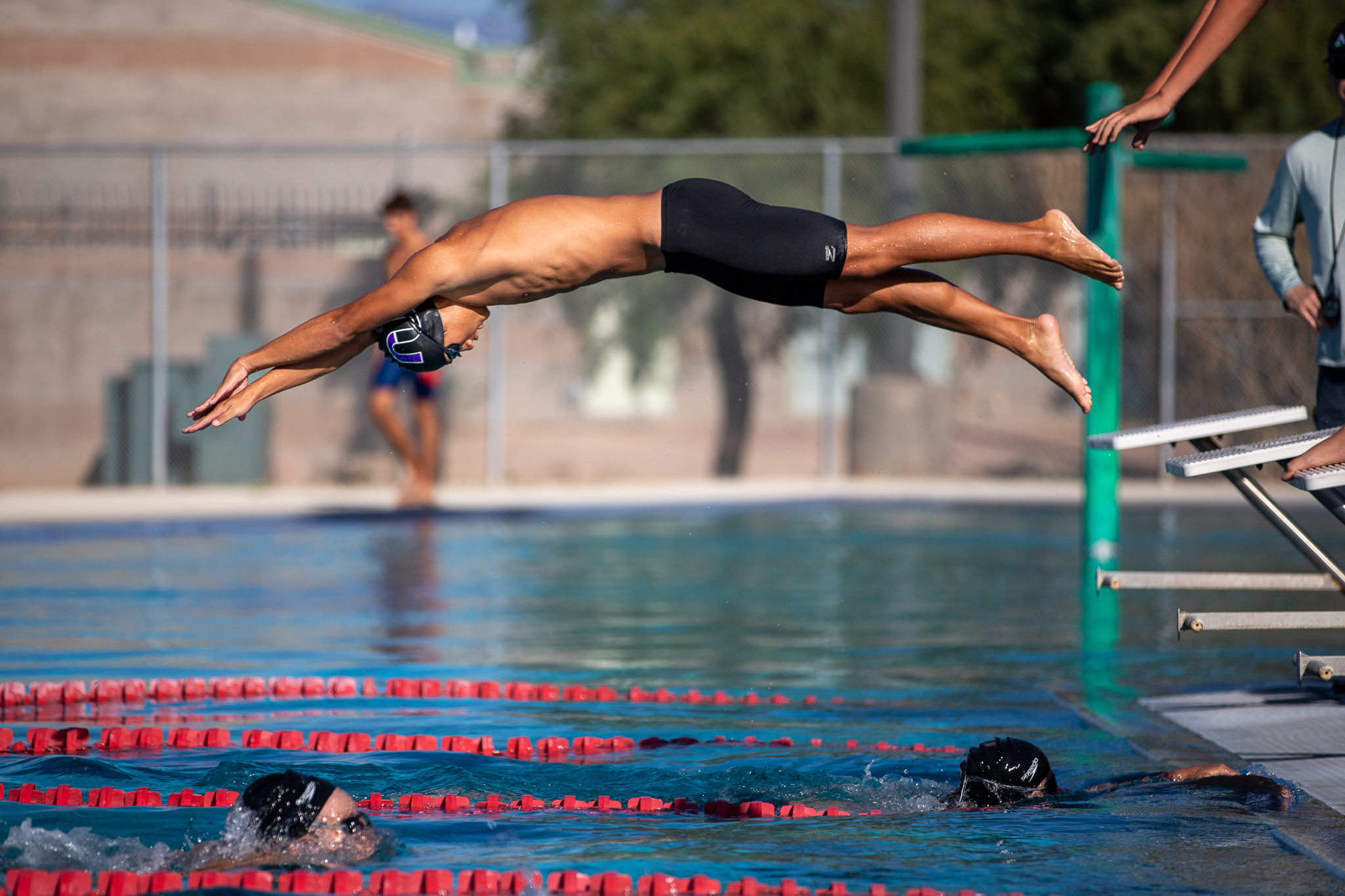 An RUHS swimmer makes a splashy dive!