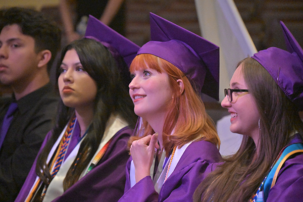 Graduates watch the ceremony