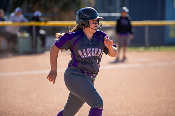 A girl runs the bases during the softball game