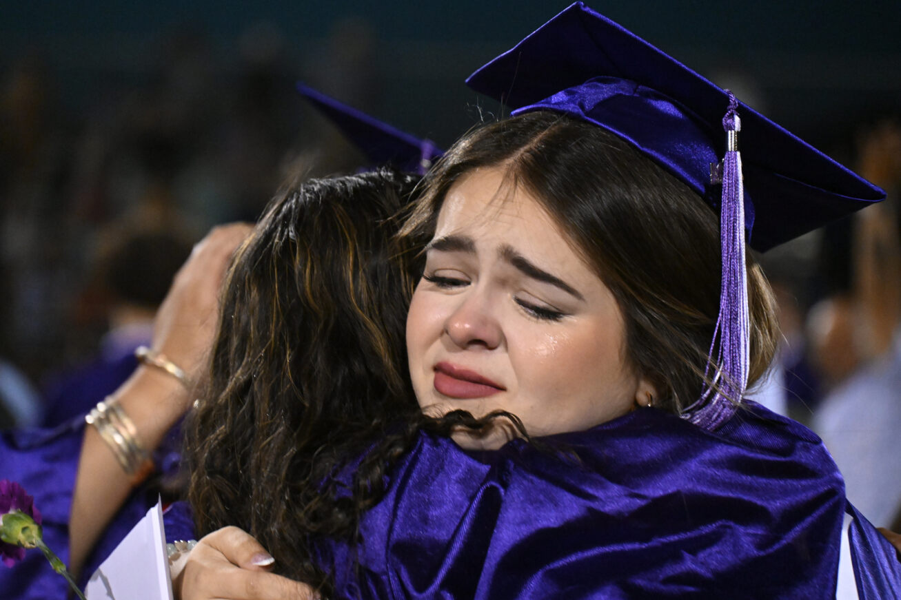 Two Rincon grads cry and hug after the cermeony