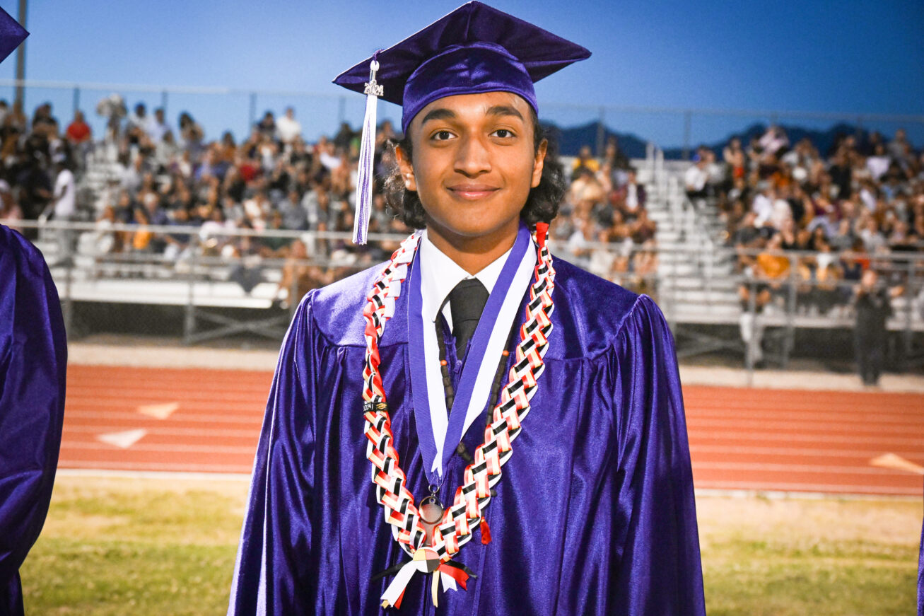 A Rincon grad smiles in his cap and gown